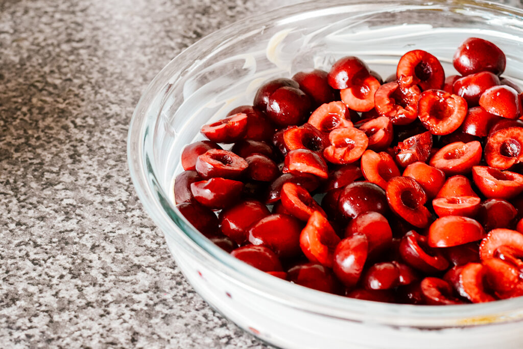 cherries in a bowl on a kitchen counter