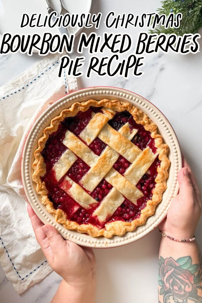 Delicious Bourbon & Mixed Berries Pie, #1 Christmas Dessert 10 A mixed berries pie with a beautifully browned lattice crust sits on a marble surface with a folded white cloth nearby, viewed from above.