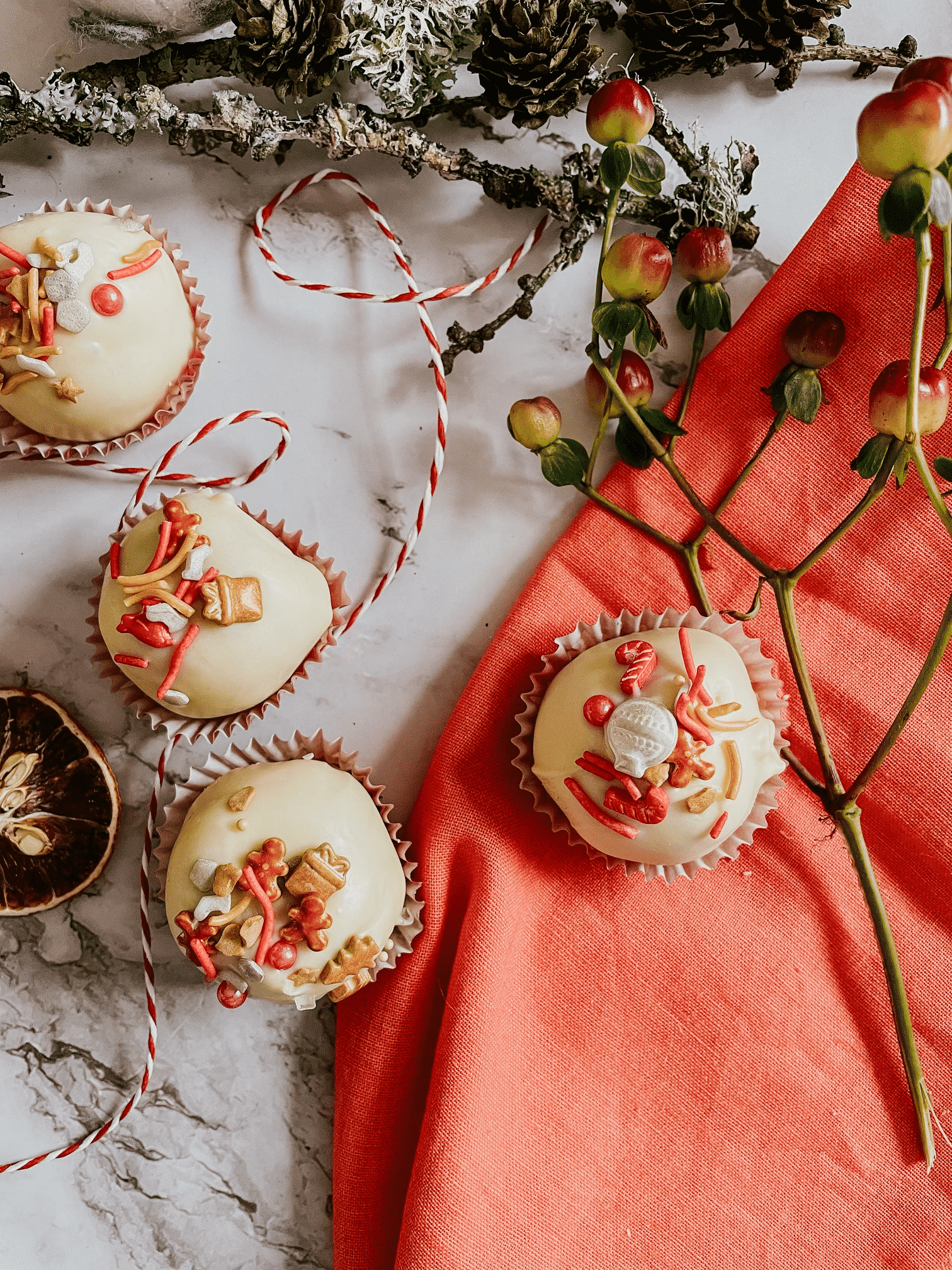 cookie truffles on a red napkin and marble background, a wooden stick on the side - above