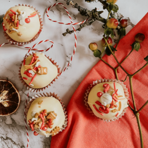 The Best No-Bake Cookie Truffles 2 cookie truffles on a red napkin and marble background, a wooden stick on the side