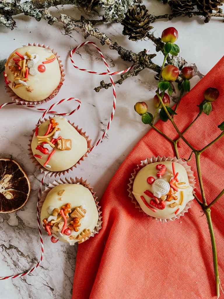 The Best No-Bake Cookie Truffles 4 cookie truffles on a red napkin and marble background, a wooden stick on the side