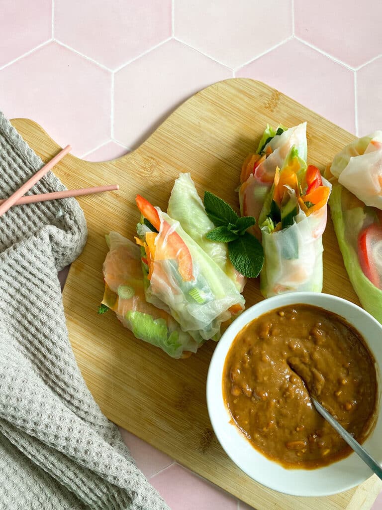 Vegan Rice Paper Rolls With Yummy Peanut Dipping Sauce 3 rice paper rolls from above with peanut dipping sauce