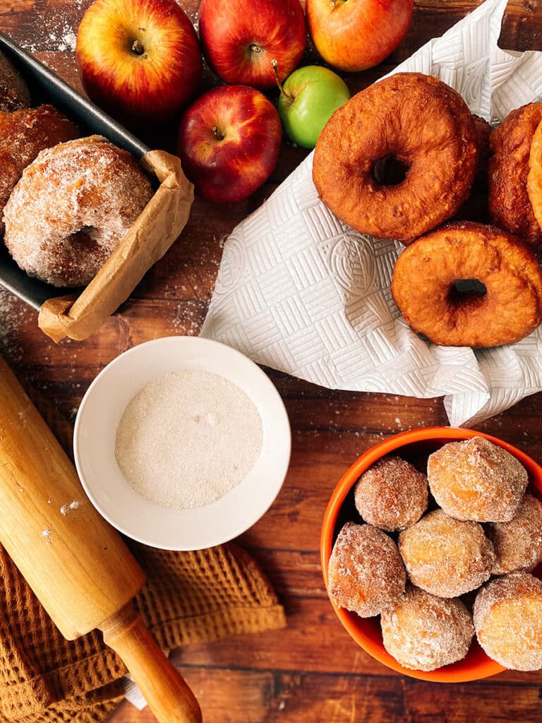 Delicious Vegan Apple Cider Doughnuts Recipe 9 close up of some vegan apple cider doughnuts before and after sugar coating