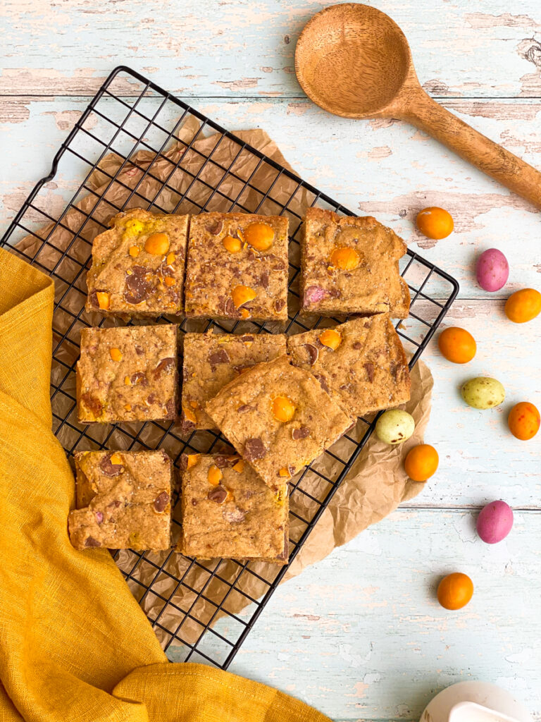 mini eggs blondies on a cookie rack, mini eggs on the side