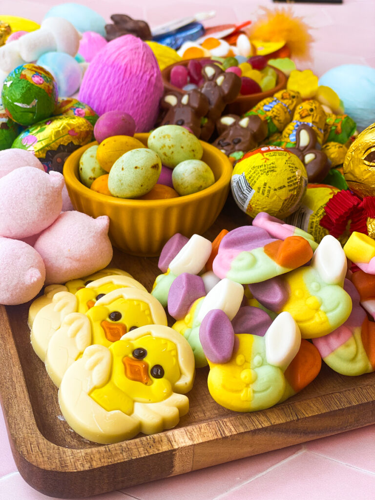 detail of the easter candy charcuterie board from above with paper covered eggs