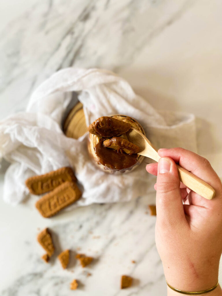 Deliciously Irresistible Biscoff Overnight Oats Recipe 3 the Biscoff overnight oats from above in a serving glass with garnish, on top of a white napkin and with lotus cookies around