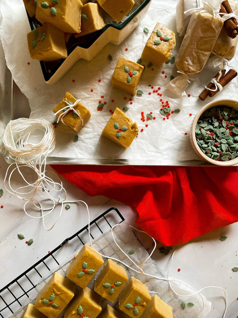 Easy No Bake Peanut Butter Fudge: Unwrap the Magic of The Best Christmas 9 easy no bake peanut butter fudge in a christmas tree dish over on a silver baking tray with christmas sprinkles