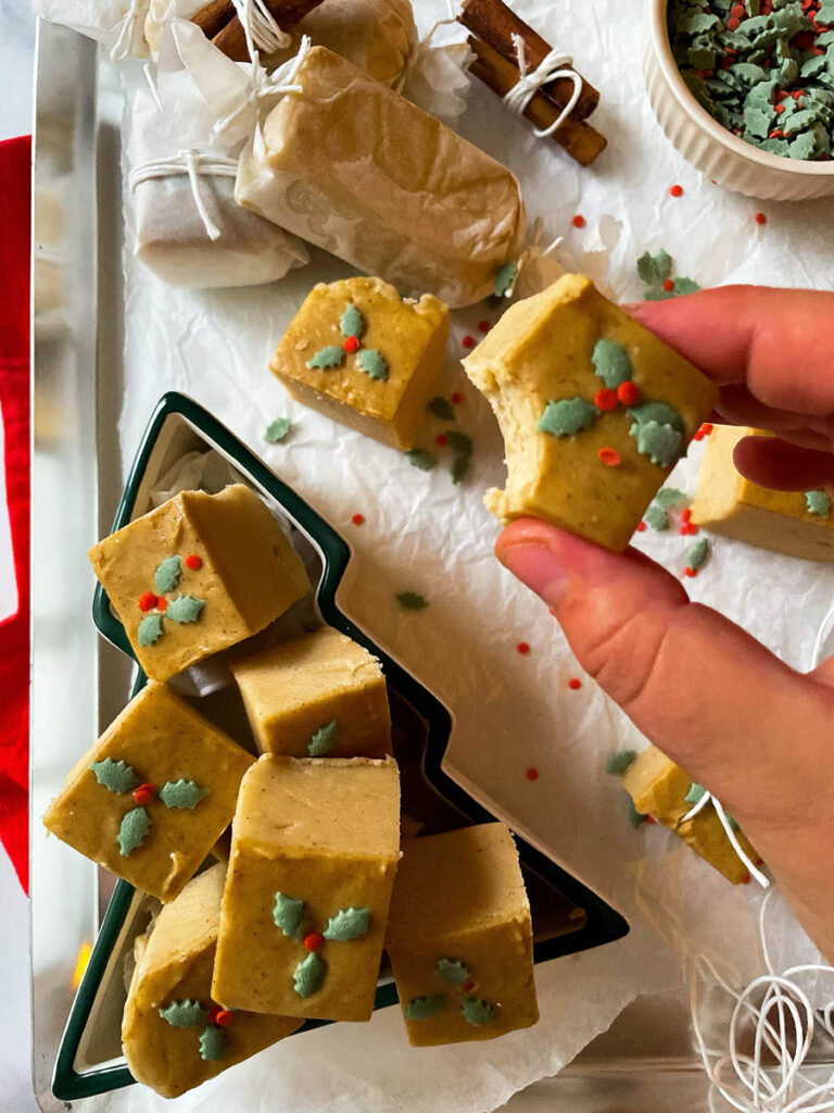 Easy No Bake Peanut Butter Fudge: Unwrap the Magic of The Best Christmas 1 easy no bake peanut butter fudge in a christmas tree dish over on a silver baking tray with christmas sprinkles