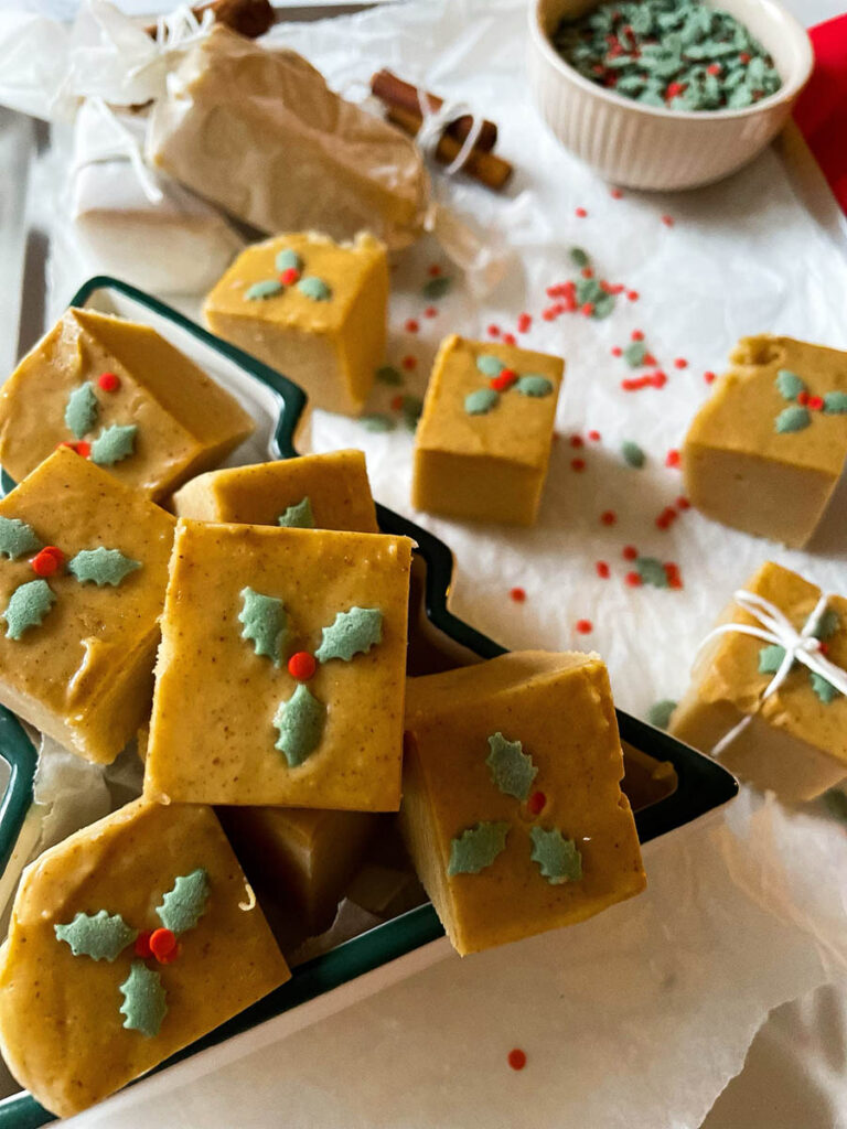 Easy No Bake Peanut Butter Fudge: Unwrap the Magic of The Best Christmas 2 easy no bake peanut butter fudge in a christmas tree dish over on a silver baking tray with christmas sprinkles