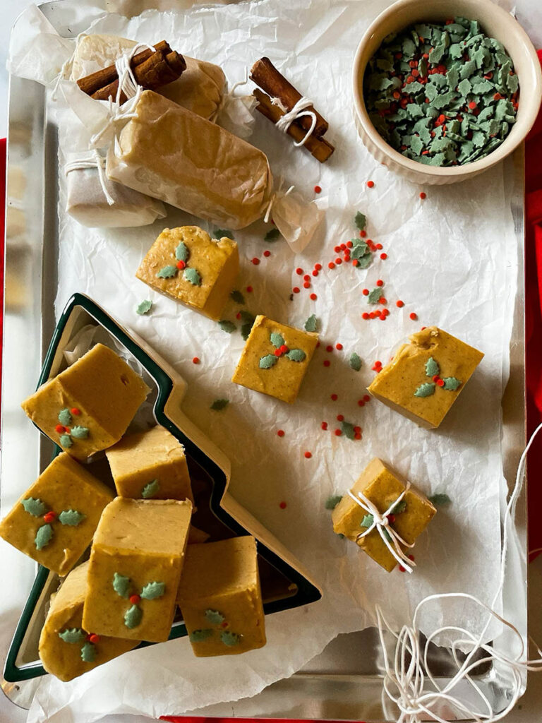 Easy No Bake Peanut Butter Fudge: Unwrap the Magic of The Best Christmas 3 easy no bake peanut butter fudge in a christmas tree dish over on a silver baking tray with christmas sprinkles
