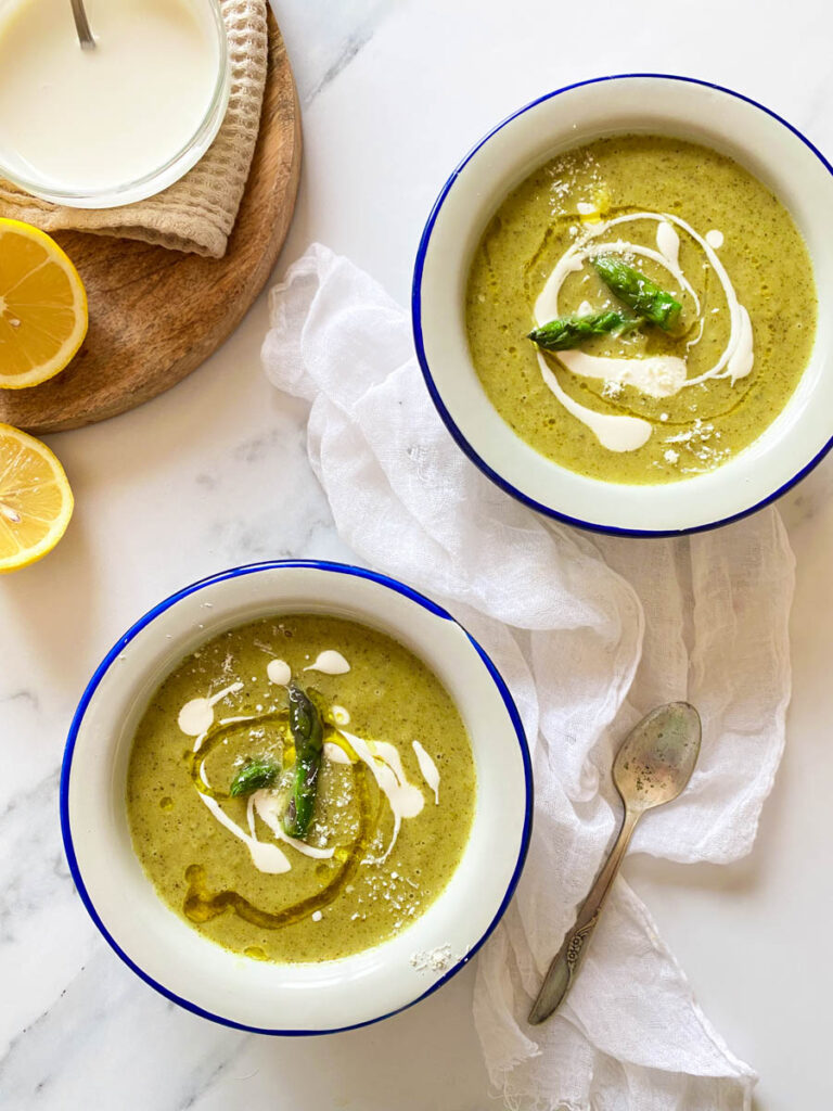 Broccoli Asparagus Soup: Delicious Lunch Idea 6 on a marble background, two towels and two bowl of broccoli asparagus soup