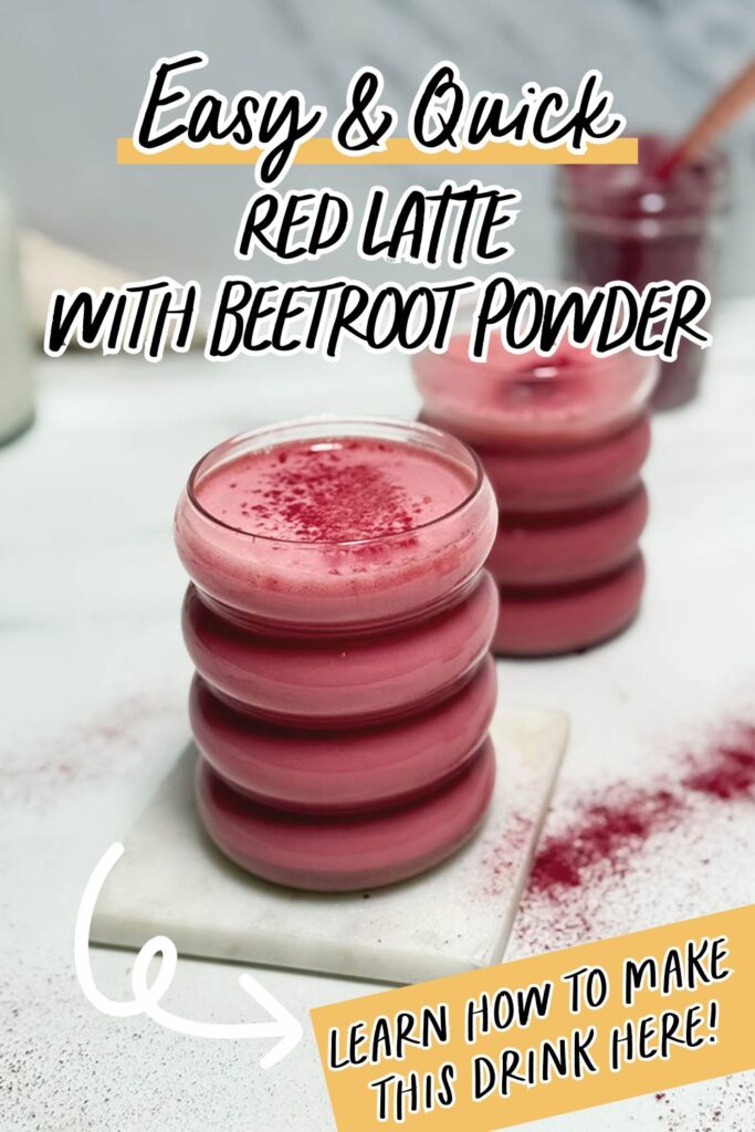 Red Latte Recipe, One Perfect For Valentine's Or Any Other Day Really 10 A promotional image featuring a vibrant red latte topped with beetroot powder, served in a ribbed glass on a white marble coaster. Text overlay reads "Easy & Quick Red Latte with Beetroot Powder" and "Learn how to make this drink here!" with a playful arrow pointing to the bottom right corner.