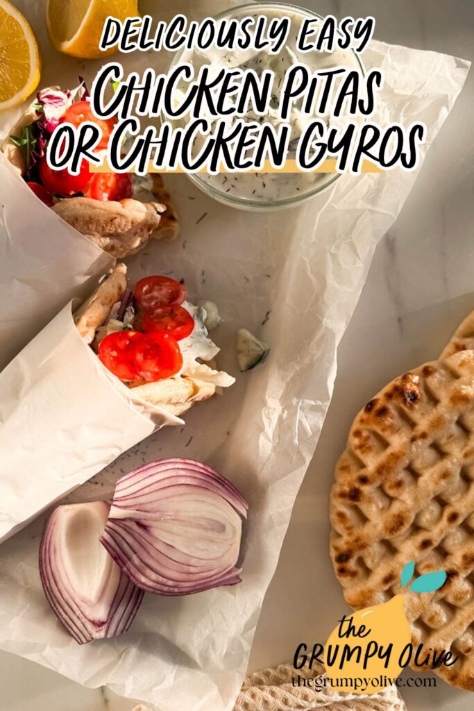 Simple Chicken Pitas, The Greek Way: Delicious And Quick 10 Flat-lay shot of chicken pitas wrapped in parchment paper, filled with grilled chicken, cherry tomatoes, mixed greens, and tzatziki sauce. The meal is accompanied by a bowl of tzatziki, red onion slices, pita bread, and lemon halves. Overlay text reads "Deliciously Easy Chicken Pitas or Chicken Gyros," with "The Grumpy Olive" logo and website URL in the bottom right corner.