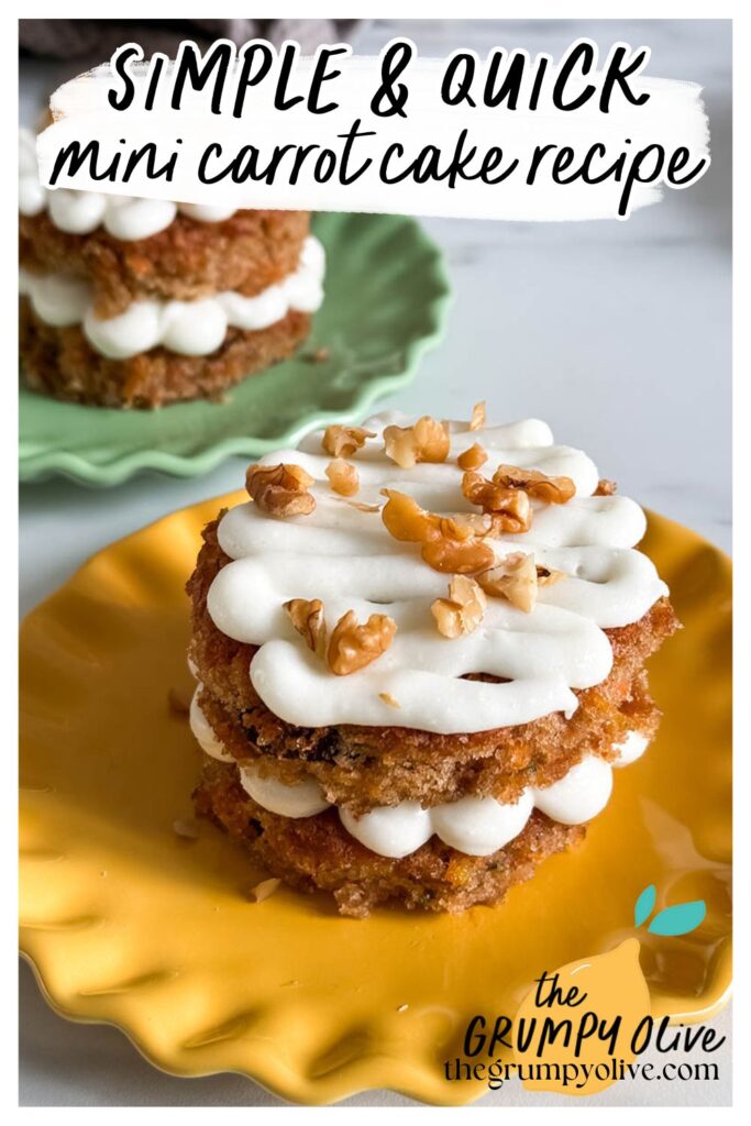 A mini carrot cake with two layers, filled and topped with piped cream cheese frosting and chopped walnuts, sits on a yellow scalloped plate. Another mini carrot cake is visible in the background on a green plate. The image includes text that reads "SIMPLE & QUICK mini carrot cake recipe" in a playful font, with "the GRUMPY Olive" logo and website URL at the bottom.