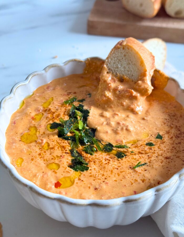 close up paprika dip in a bowl with bread