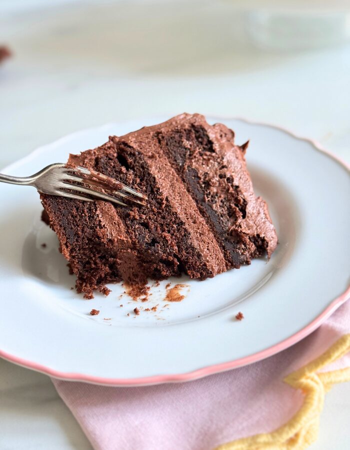 close up of a slice of matildas cake with a fork on top, towel under