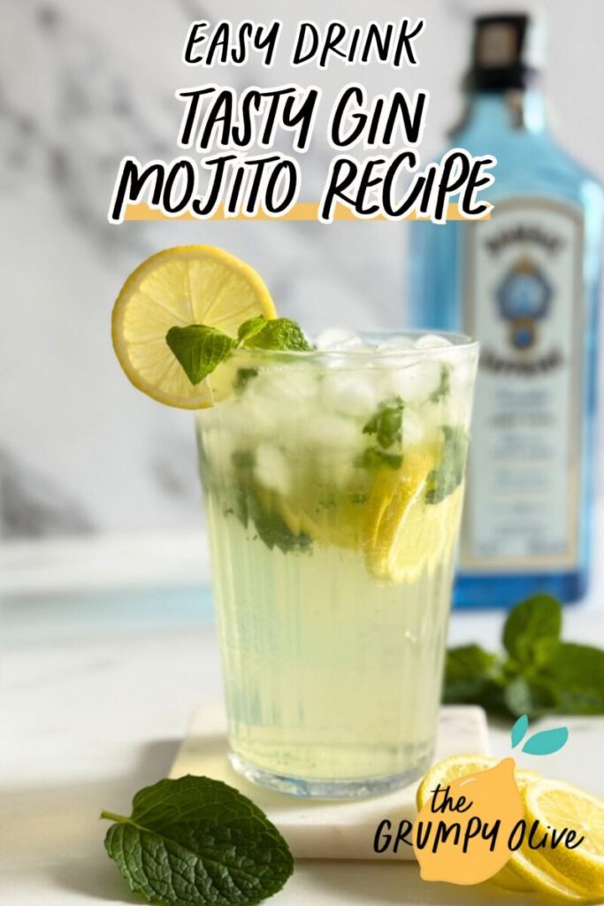 Easy Gin Mojitos - 5 Minute Twist On A Classic Mojito 15 pin image gin mojitos in a glass and mint and lemon, on a marble coaster, spoon, behind wooden boards, a bottle of sapphire gin and a container with club soda, on marble background