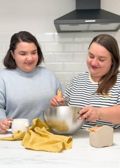 About 2 portrait of two girls in a white kitchen with kitchen tools