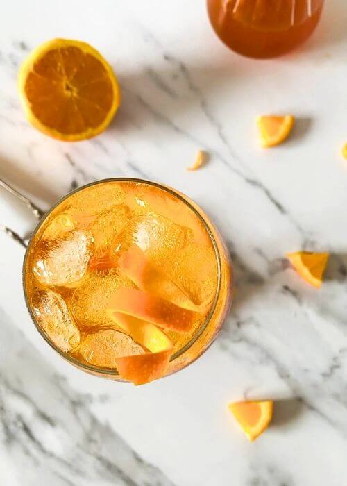 Super Aperol Spritz Mocktail, Just Like The Real One 6 from top aperol spritz mocktail, marble background, ice tongues and slices of orange around