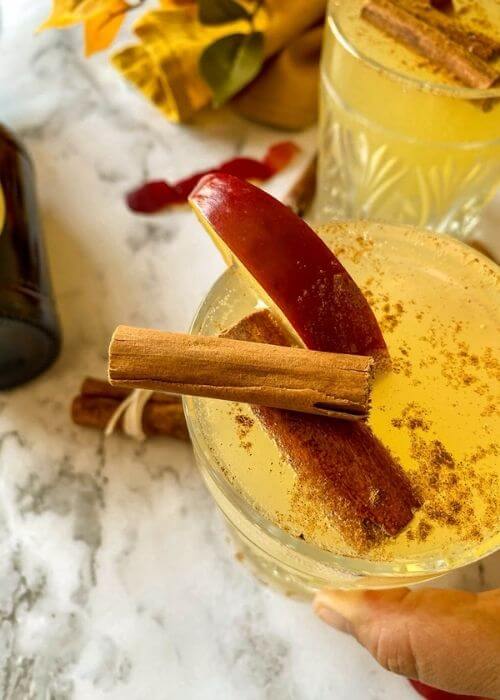 Quick Apple Fizz Mocktail, Delicious Fall Drink 5 close up of apple fizz mocktail with towel and apples around