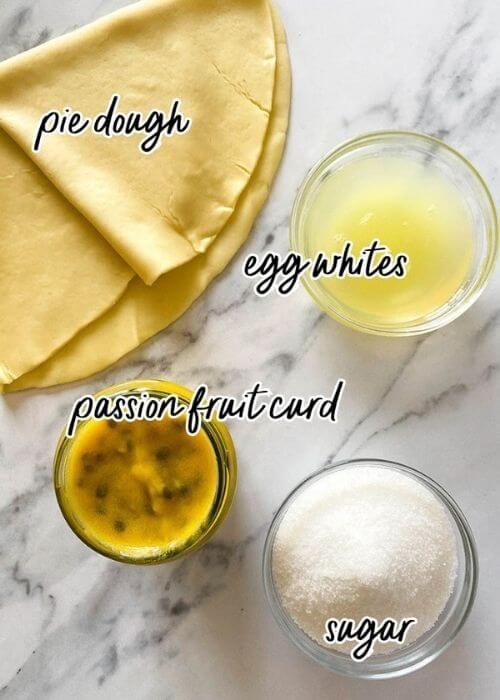 Delicious Passion Fruit Meringue Pie 3 ingredients for passion fruit meringue pie in bowls on a marble background
